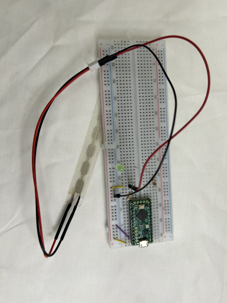 A prototyping breadboard with a teensy LC connected to a floor sensor.